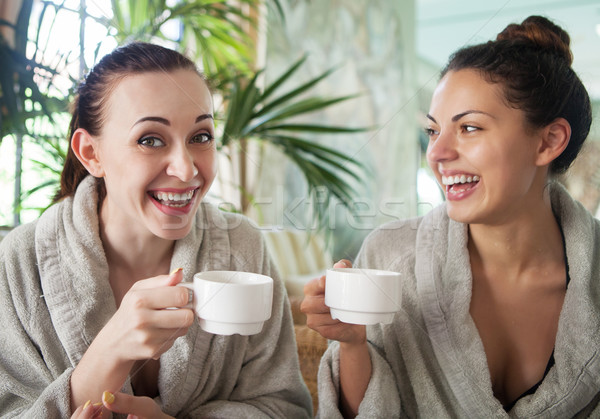 Young happy women drinking tea at spa resort Stock photo © dashapetrenko