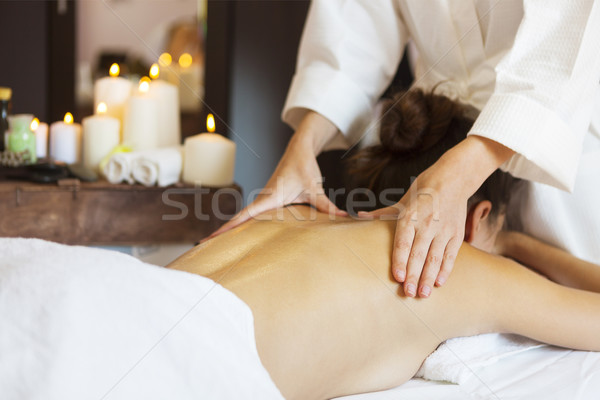 Beautiful young woman relaxing with hand massage at beauty spa Stock photo © dashapetrenko
