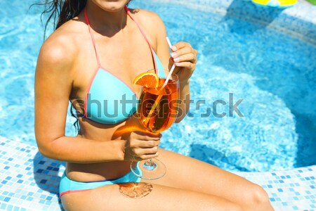Sexy girl near the pool holding green ball Stock photo © dashapetrenko