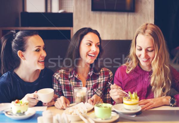 Three young women at a meeting in a cafe Stock photo © dashapetrenko