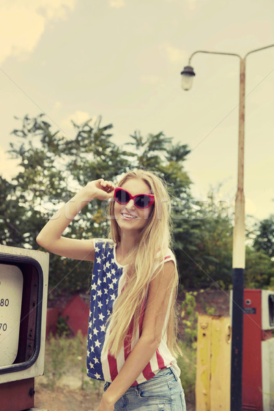 Blond girl holds hands on her glasses  Stock photo © dashapetrenko