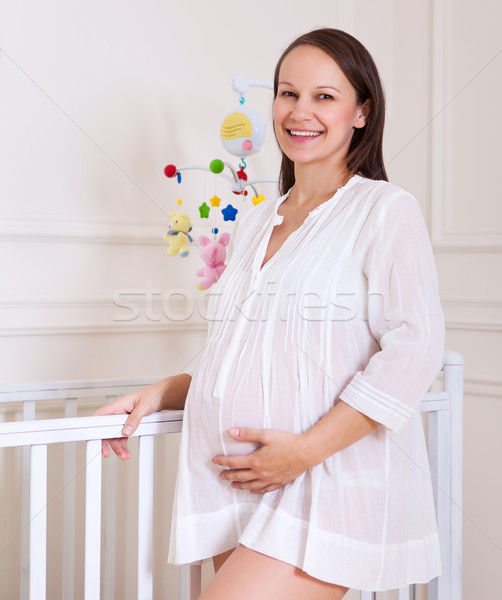 Mosolyog terhes nő faiskola szoba portré fiatal Stock fotó © dashapetrenko