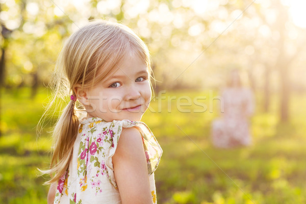 Happy mother and her little daughter in a blossoming garden Stock photo © dashapetrenko