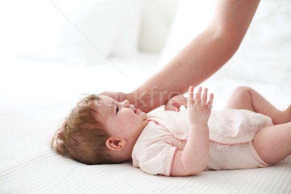 Six month baby on bed playing with father Stock photo © dashapetrenko