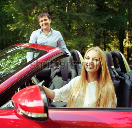 Beautiful blond young woman standing near a sports car Stock photo © dashapetrenko