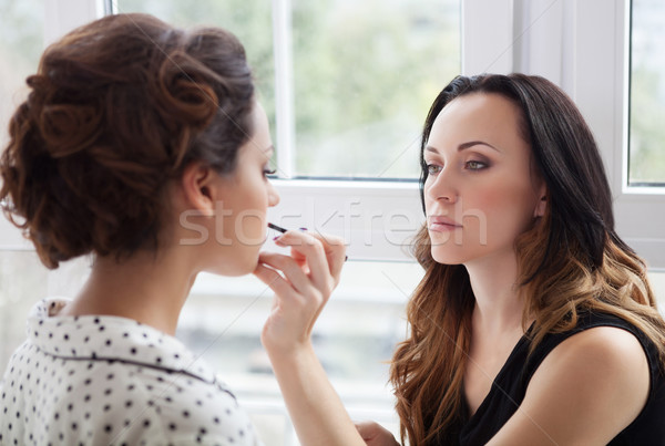 Make-up artist doing make up for young beautiful bride Stock photo © dashapetrenko