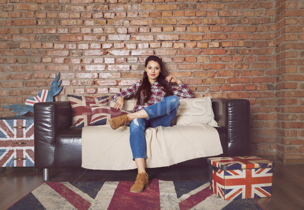 Pretty hipster girl sitting on couch at home  Stock photo © dashapetrenko