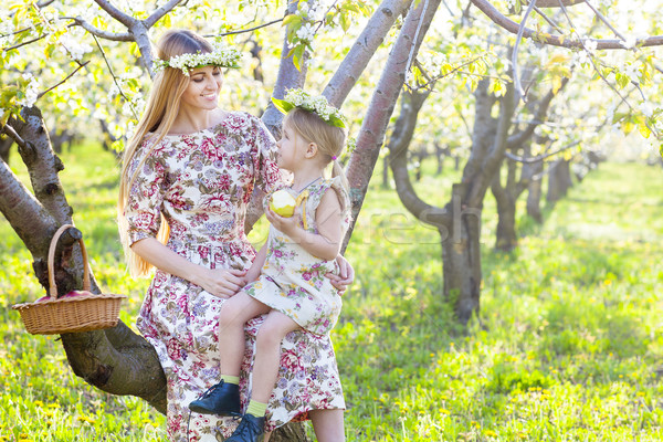 Happy mother and her little daughter in a blossoming garden Stock photo © dashapetrenko