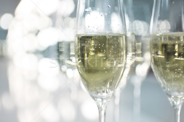 Champagne glasses on white background in bright lights Stock photo © dashapetrenko