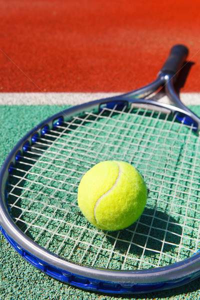 Tennis racquet and ball on the clay tennis court Stock photo © dashapetrenko