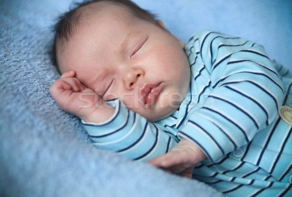 Stock photo: Peaceful baby lying on a bed while sleeping 