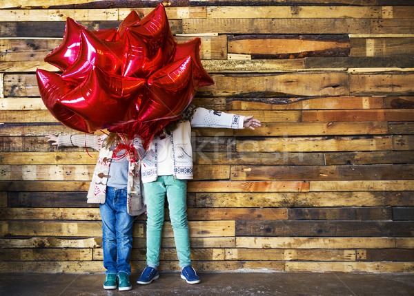 Children with balloons at wooden wall Stock photo © dashapetrenko