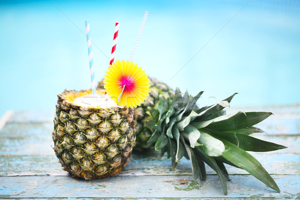Exotic pineapple cocktail near pool. Pina colada Stock photo © dashapetrenko