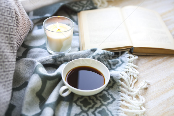 Cup of coffee, candle and book on the floor Stock photo © dashapetrenko