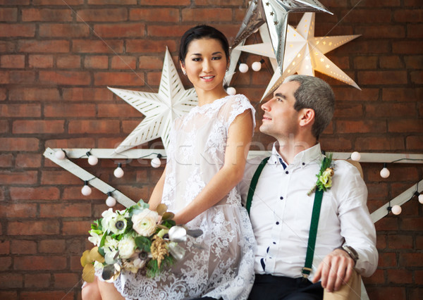 Derűs házaspár áll téglafal díszített csillagok Stock fotó © dashapetrenko