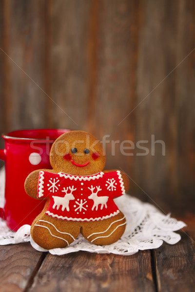 Smiling christmas gingerbread men on wooden background.  Stock photo © dashapetrenko