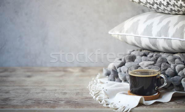 Grey pillows and cup of coffee on the wall background Stock photo © dashapetrenko
