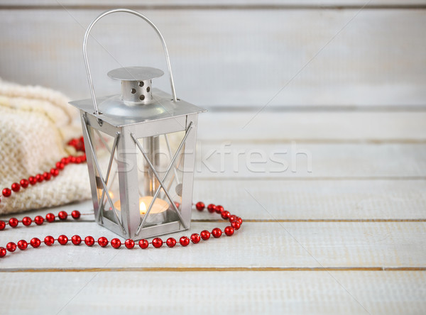 Christmas still life with lantern and red beads on wooden backgr Stock photo © dashapetrenko