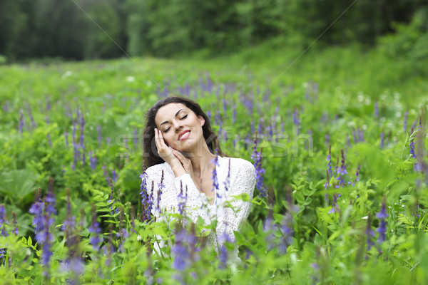 Happy pretty brunette woman in flower field Stock photo © dashapetrenko