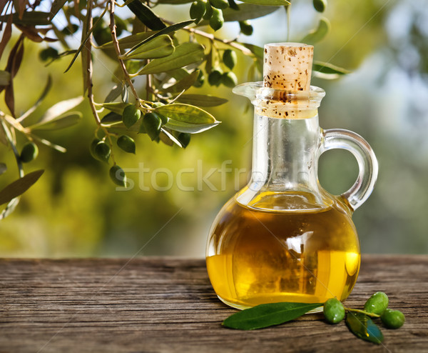 Olive oil and olive branch on the wooden table  Stock photo © dashapetrenko