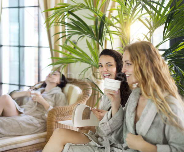 Three young women drinking tea at spa resort Stock photo © dashapetrenko