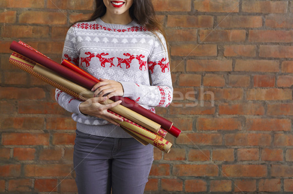Young woman holding hands closeup wrapping kraft paper rolls for Stock photo © dashapetrenko