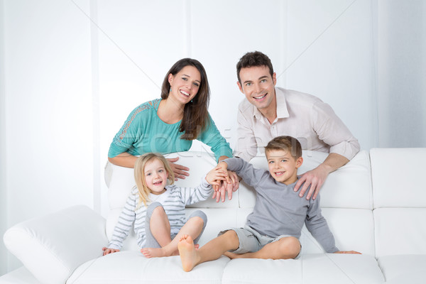 Derűs család fehér kanapé portré fiatal Stock fotó © Dave_pot