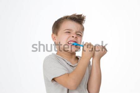 boy is hurting while cleaning teeth Stock photo © Dave_pot