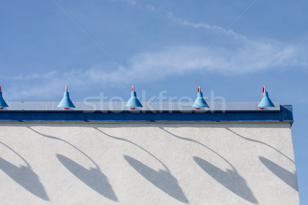Shadows of Old Blue Lamps on White Stucco Stock photo © dbvirago