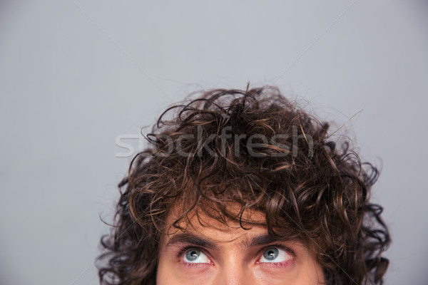 Férfi göndör haj felfelé néz copy space kép szürke Stock fotó © deandrobot