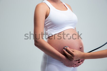 Mulher grávida estetoscópio isolado branco mulher bebê Foto stock © deandrobot