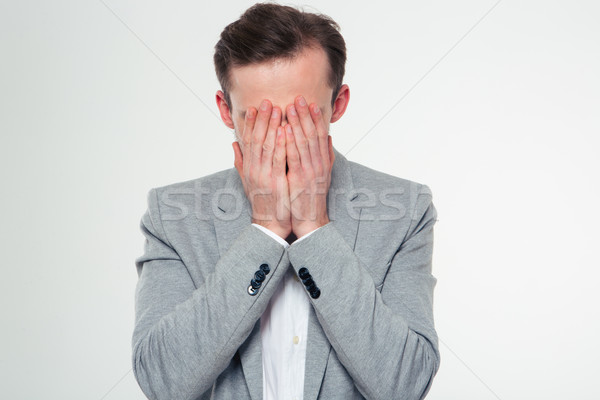 Stressed businessman covering her face with palms Stock photo © deandrobot