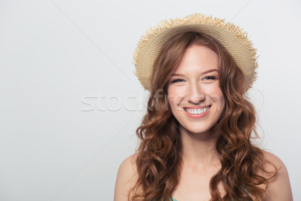 Smiling woman with hat looking at camera Stock photo © deandrobot