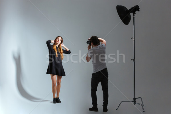 Photographer working with model in studio  Stock photo © deandrobot