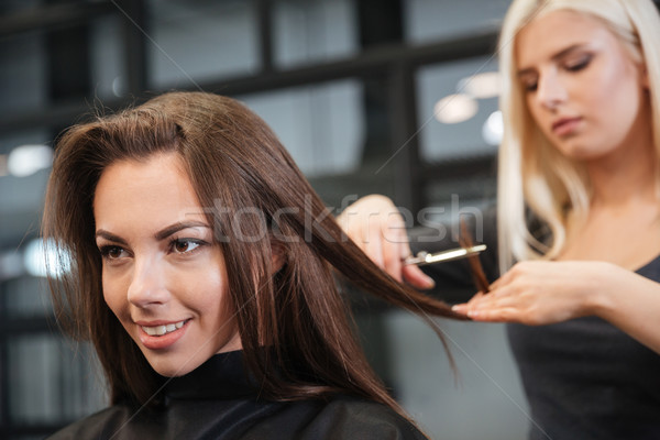 Hairdresser giving a new haircut to female customer at parlor Stock photo © deandrobot
