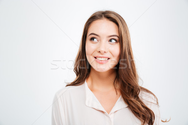Portrait of a casual young smiling girl thinking about something Stock photo © deandrobot