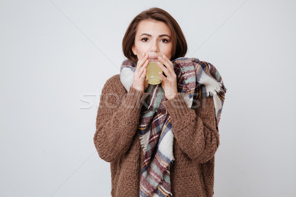 Sick young lady holding glass with medicine Stock photo © deandrobot