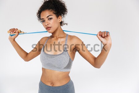 Portrait of a young woman working out with dumbbells Stock photo © deandrobot