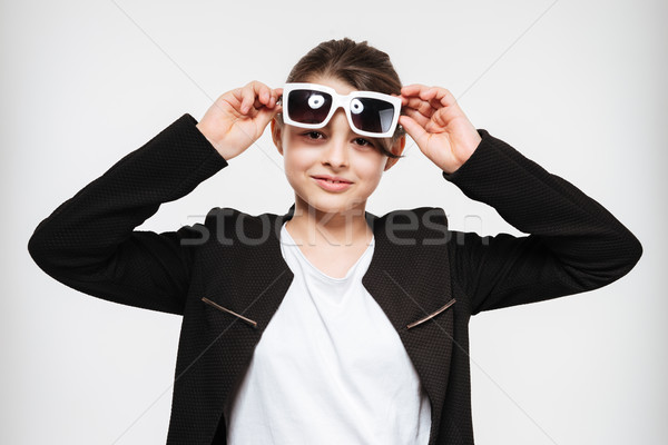 Cheerful young girl wearing sunglasses Stock photo © deandrobot