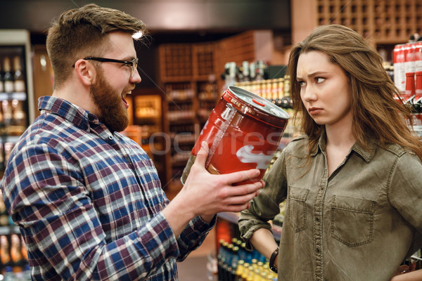 Man showing keg of beer to your woman Stock photo © deandrobot