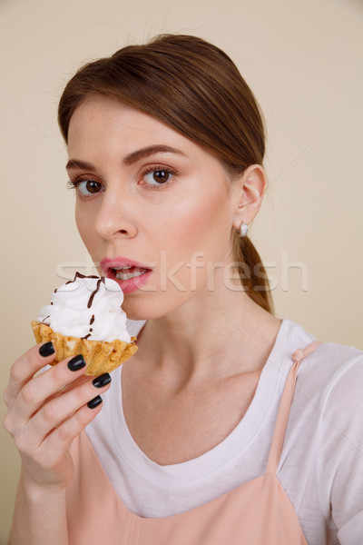 Vertical image of woman eating cake Stock photo © deandrobot