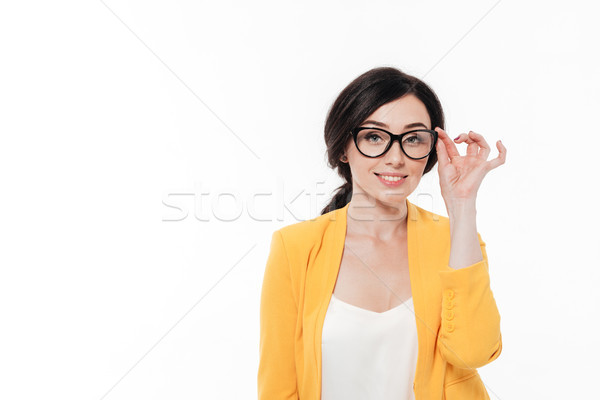 Portrait jeune femme lunettes veste permanent regarder [[stock_photo]] © deandrobot