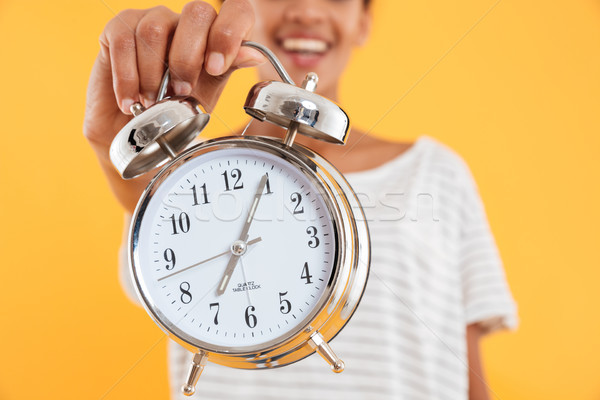 Close up of alarm clock in woman's hand isolated Stock photo © deandrobot