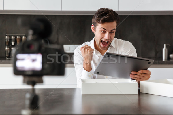 Screaming excited young man filming his video Stock photo © deandrobot