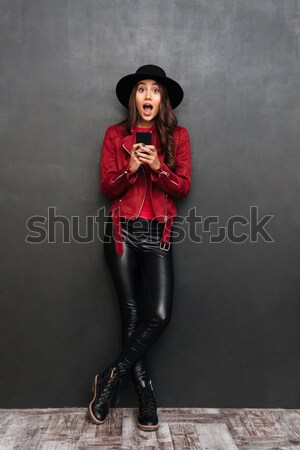 Cheerful young beautiful woman with arms crossed Stock photo © deandrobot