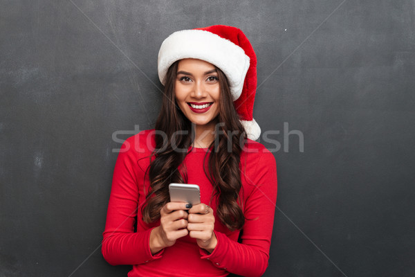 Sorridente morena mulher vermelho blusa natal Foto stock © deandrobot