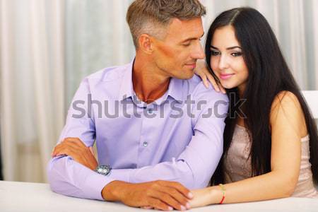 Portrait of happy couple man and woman in basic clothing hugging Stock photo © deandrobot