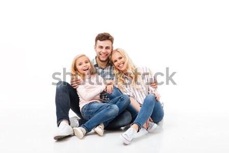 Image of pleased man and woman hugging together while sitting on Stock photo © deandrobot