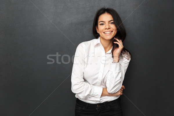 Image of beautiful woman wearing businesslike outfit smiling and Stock photo © deandrobot