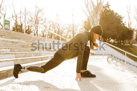 Image of disabled running girl in sportswear, doing sit ups and  Stock photo © deandrobot